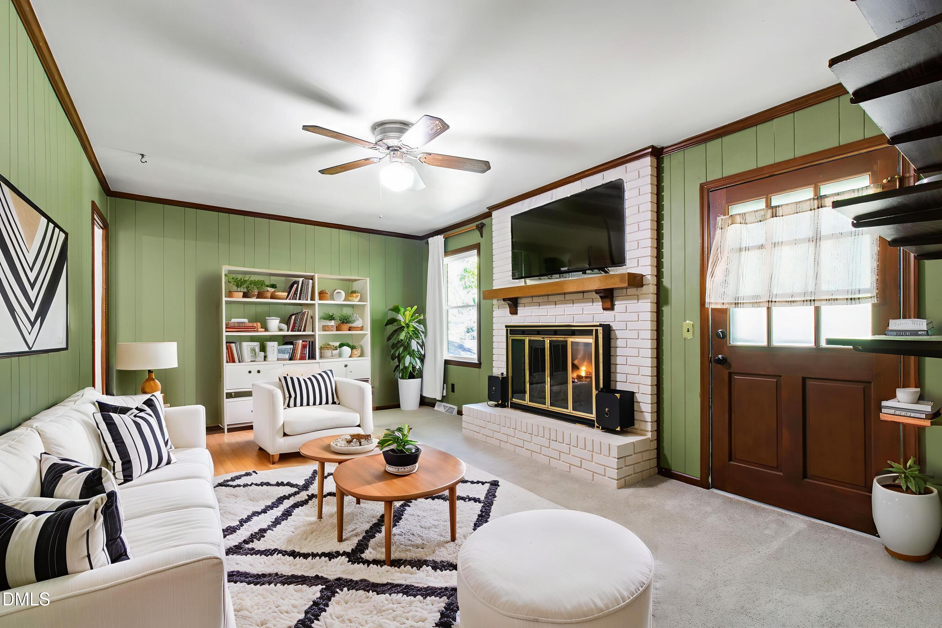 4606 Greenbrier Road Raleigh, NC 27603 - Photo 20 of 49 a living room with furniture a fireplace and a flat screen tv
