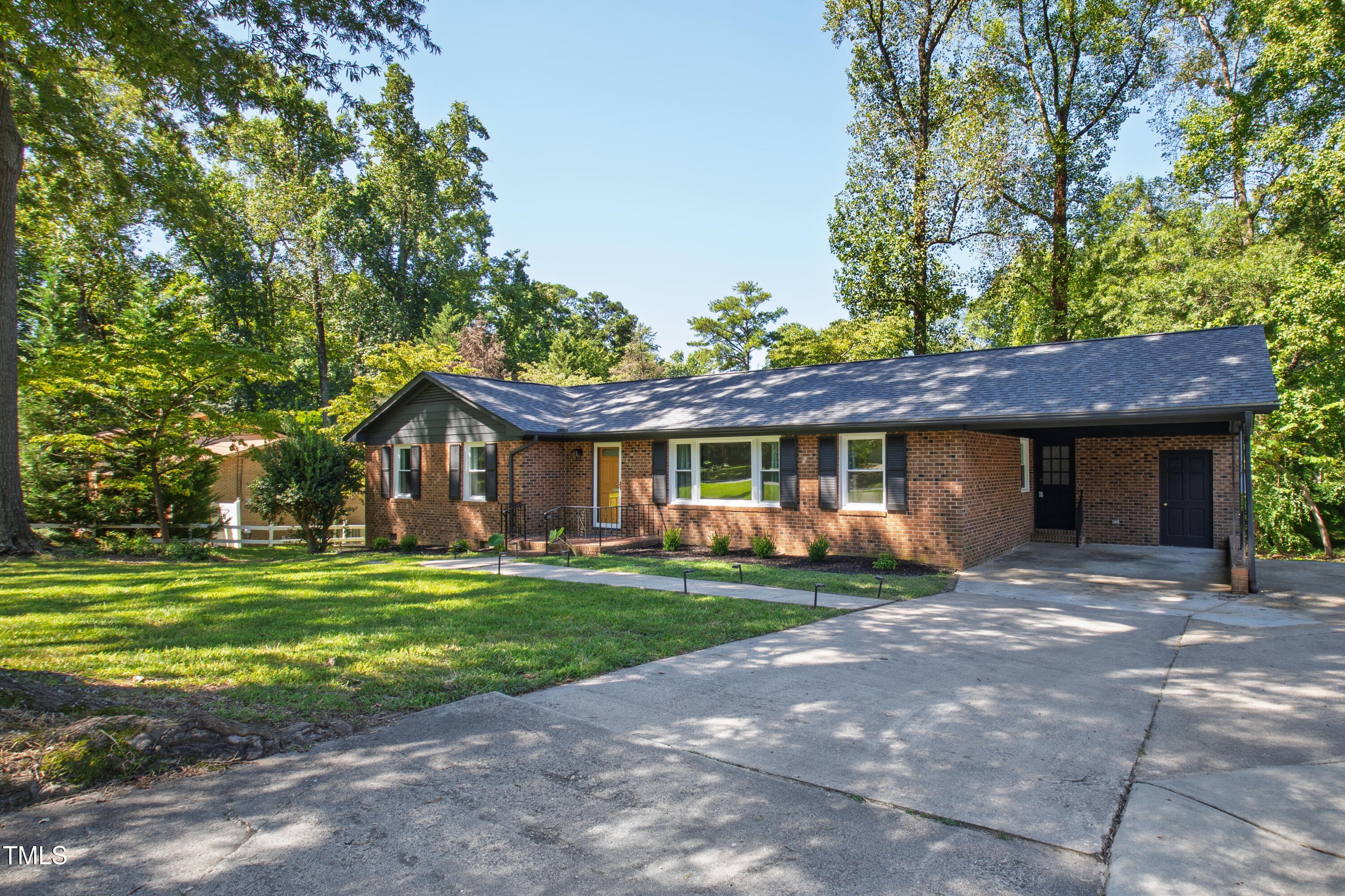 4606 Greenbrier Road Raleigh, NC 27603 - Photo 2 of 49 a front view of a house with a garden