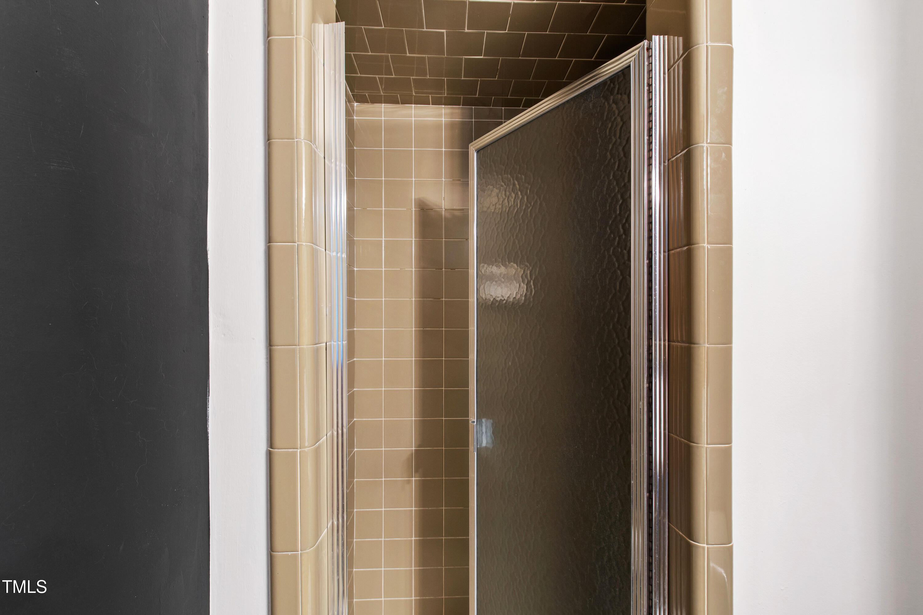 4606 Greenbrier Road Raleigh, NC 27603 - Photo 27 of 49 a bathroom with a glass door shower and a mirror