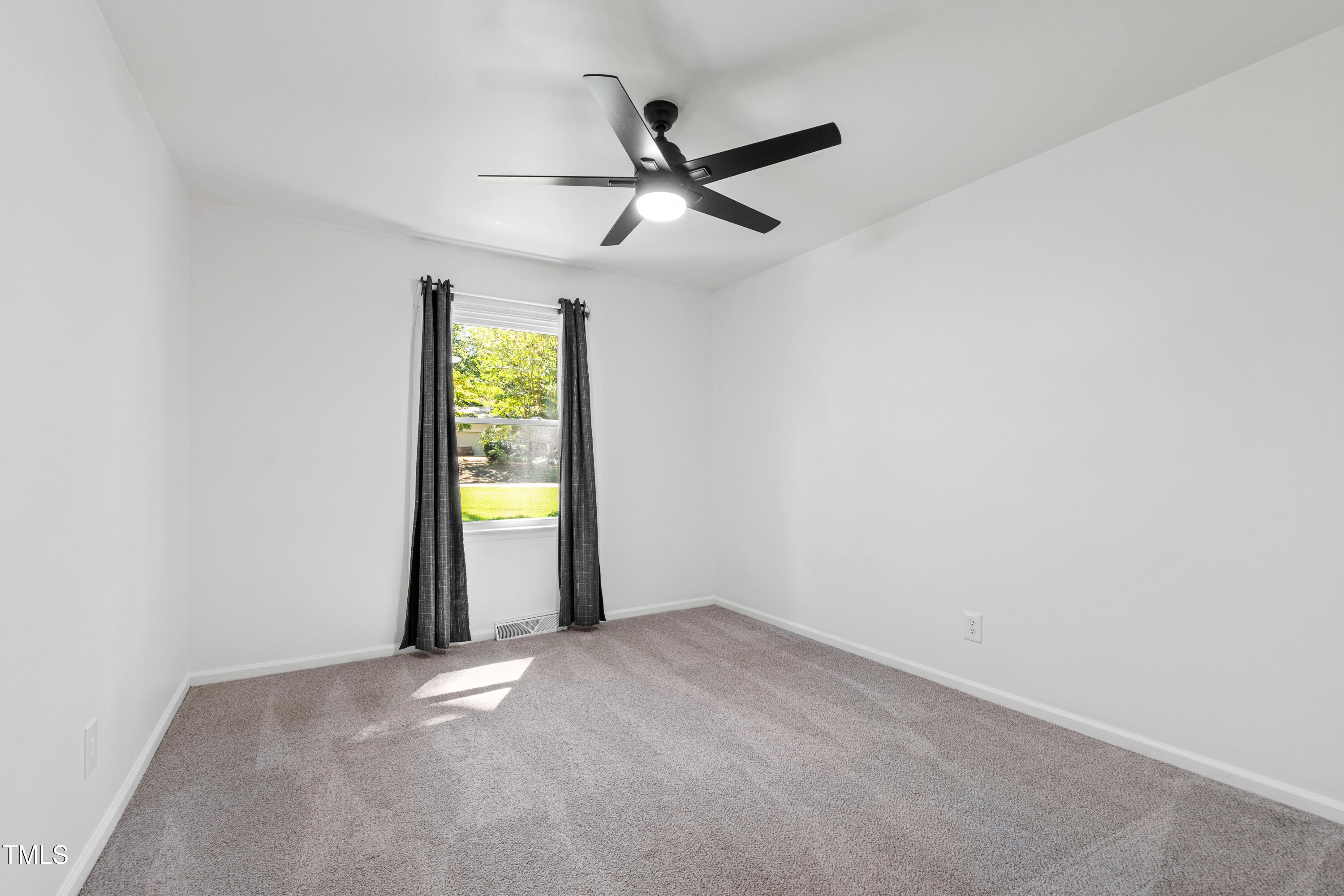 4606 Greenbrier Road Raleigh, NC 27603 - Photo 28 of 49 an empty room with window and fan