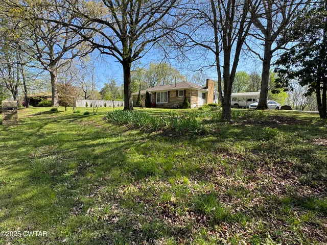 a view of house with yard