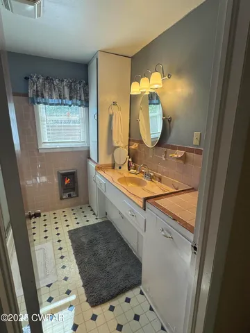 a bedroom with a bed and a large mirror