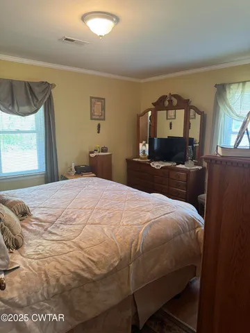 a bedroom with a bed and window