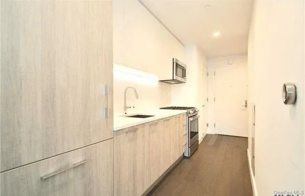 a kitchen with a sink and a refrigerator