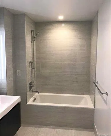 a bathroom with a bathtub and a shower
