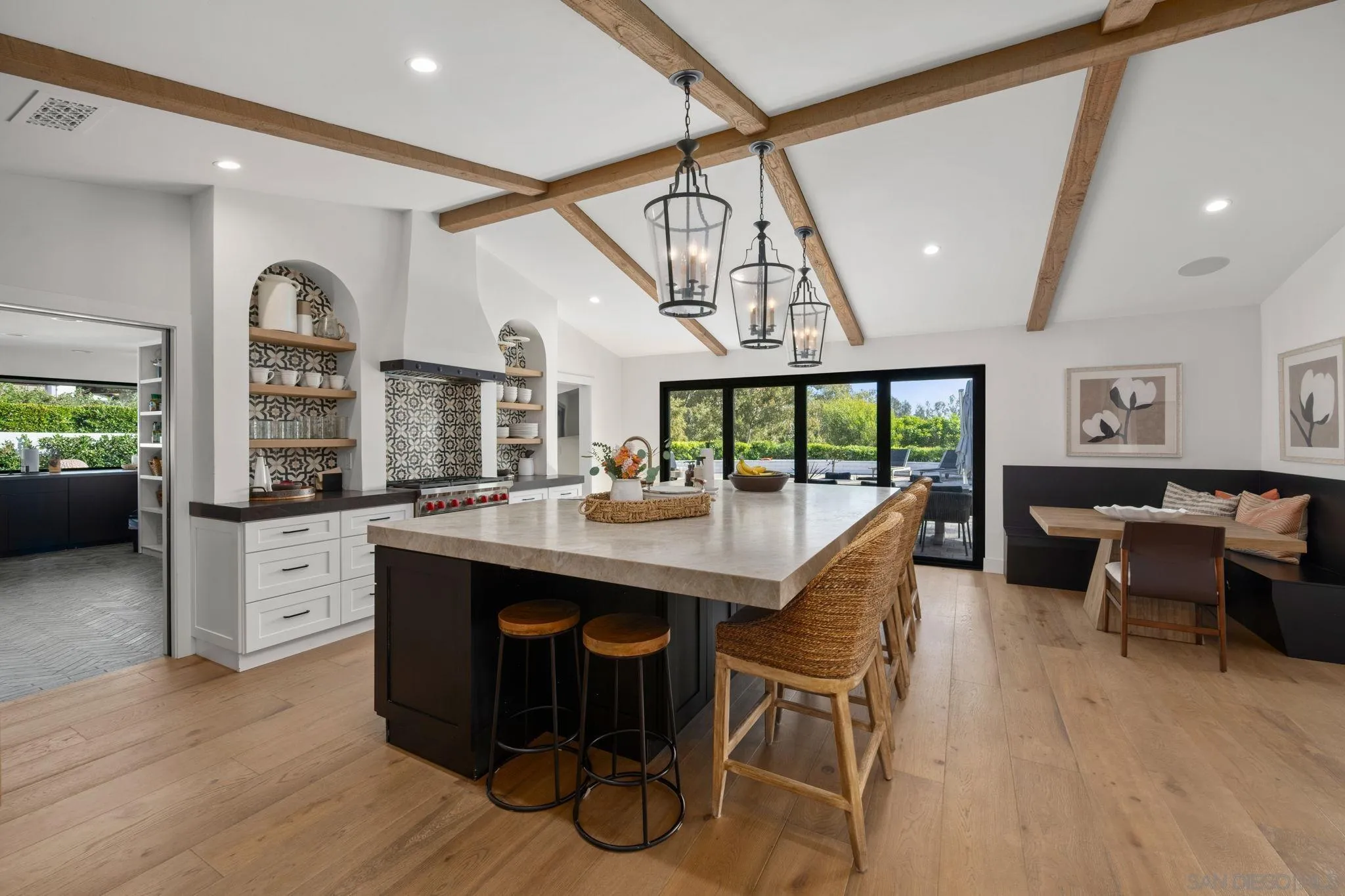 5424 El Cielito Rancho Santa Fe, CA 92067 - Photo 7 of 22 a kitchen with stainless steel appliances granite countertop a kitchen island a stove a table and chairs in it