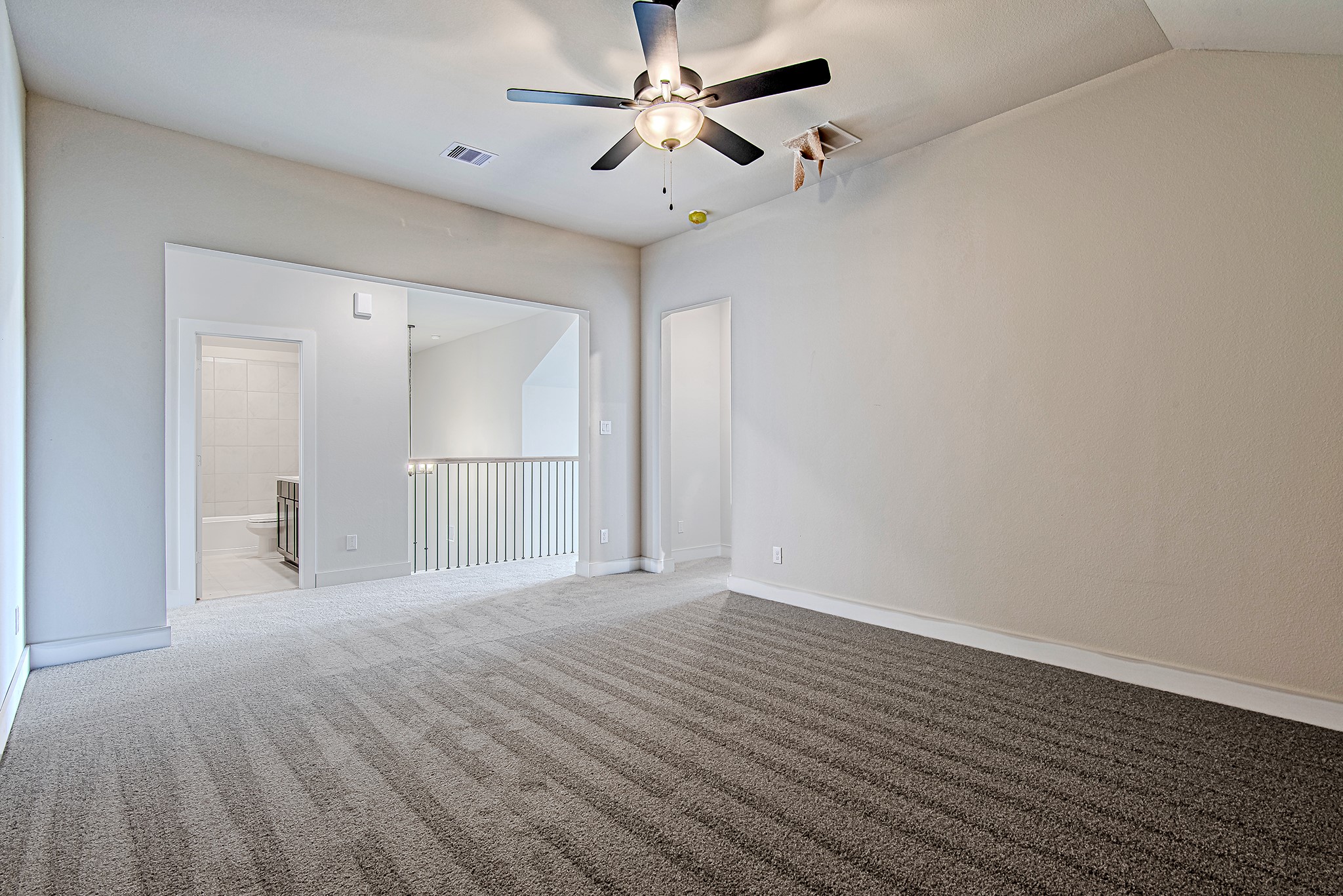 141 Peninsula Point Drive Montgomery, TX 77356 - Photo 32 of 47 Spacious upstairs bonus area ideal for lounging, study, or play—with views overlooking the stair railing and easy access to the full bathroom.