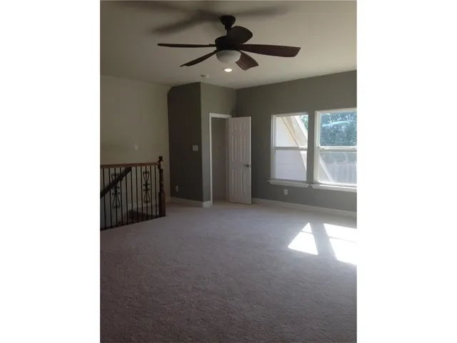 a view of a livingroom with a ceiling fan and window