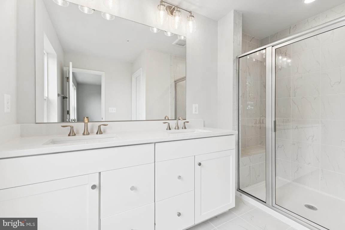 9656 Killenney Place Waldorf, MD 20601 - Photo 15 of 25 a bathroom with double sink and a mirror