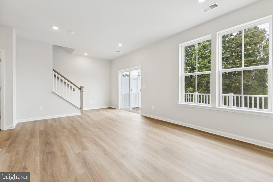9656 Killenney Place Waldorf, MD 20601 - Photo 21 of 25 a view of an empty room with a window and wooden floor
