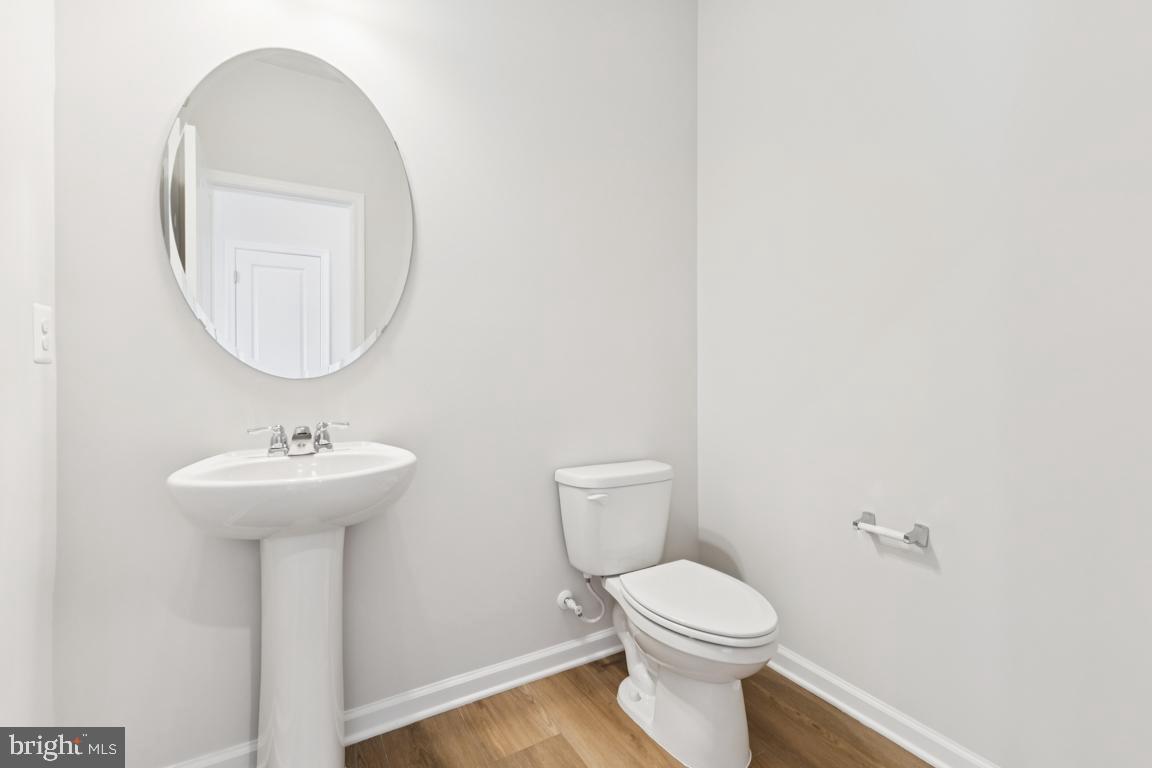 9656 Killenney Place Waldorf, MD 20601 - Photo 22 of 25 a bathroom with a sink a mirror and a toilet