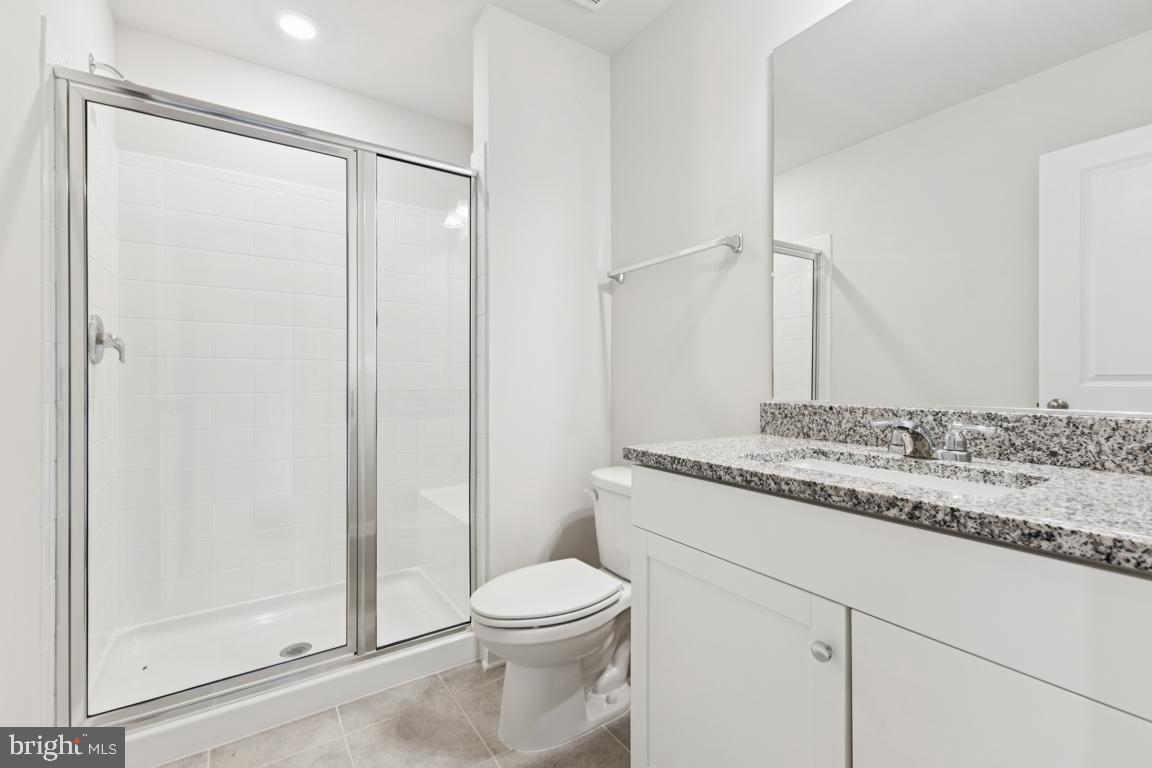 9656 Killenney Place Waldorf, MD 20601 - Photo 25 of 25 a bathroom with a granite countertop sink toilet and shower