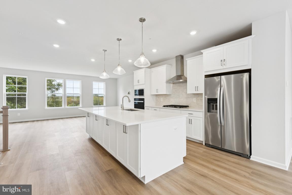 9656 Killenney Place Waldorf, MD 20601 - Photo 3 of 25 a large white kitchen with stainless steel appliances