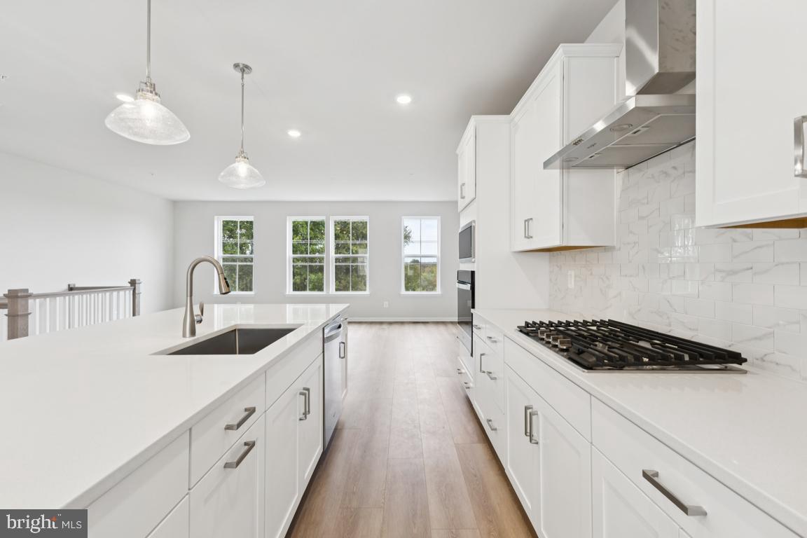 9656 Killenney Place Waldorf, MD 20601 - Photo 5 of 25 a kitchen with granite countertop a stove and a sink