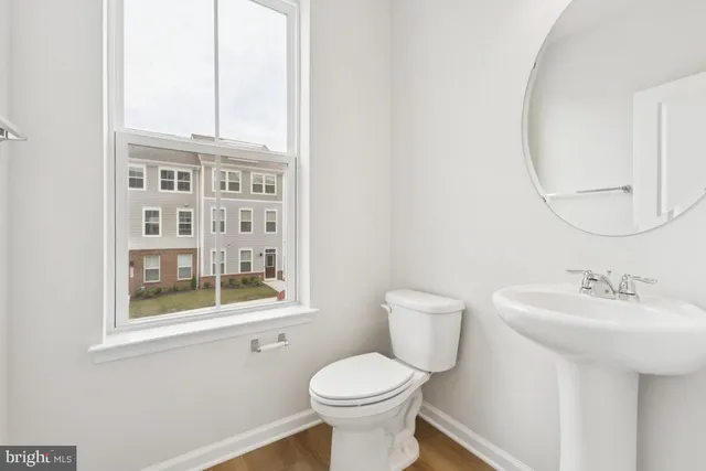 a view of a big room with wooden floor and windows