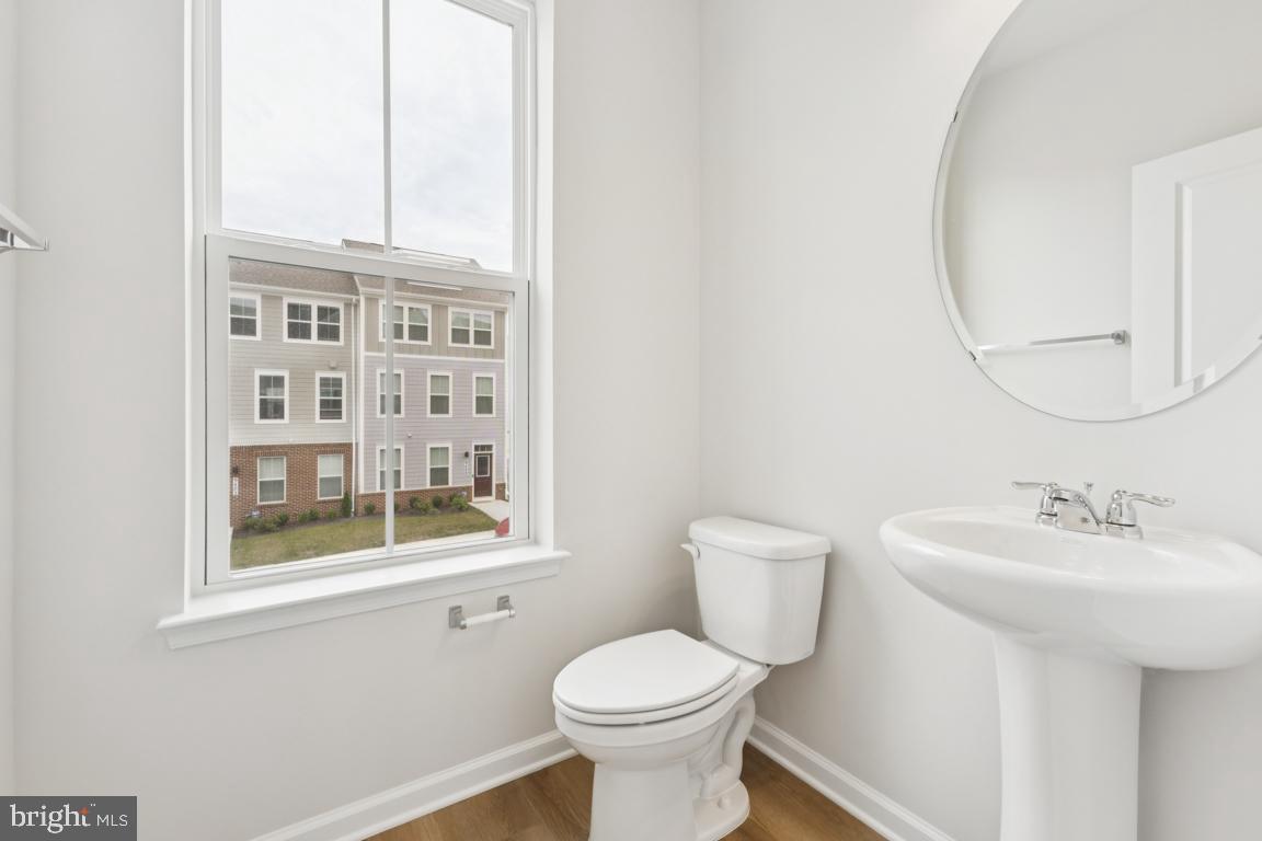 9656 Killenney Place Waldorf, MD 20601 - Photo 8 of 25 a bathroom with a sink a toilet and a mirror