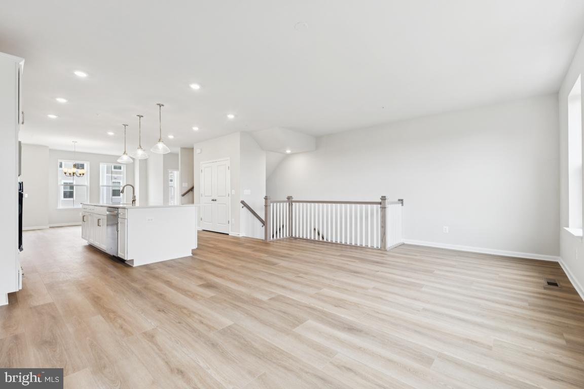 9656 Killenney Place Waldorf, MD 20601 - Photo 10 of 25 a view of a big room with wooden floor and windows