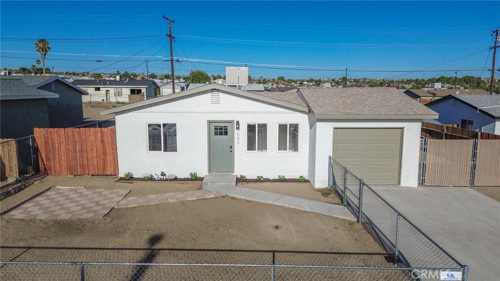 650 Chateau Way Barstow, CA 92311 - Photo 1 of 1 a front view of a house with a yard
