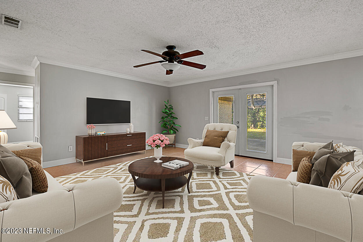 3759 Rustic Lane Jacksonville, FL 32217 - Photo 15 of 32 a living room with furniture a flat screen tv and a large window