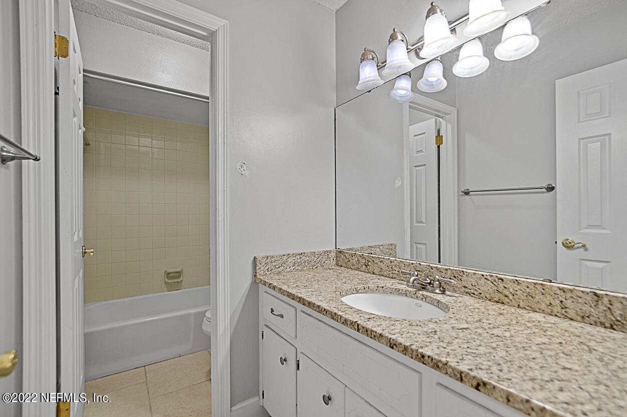 3759 Rustic Lane Jacksonville, FL 32217 - Photo 21 of 32 a bathroom with a granite countertop sink and a mirror
