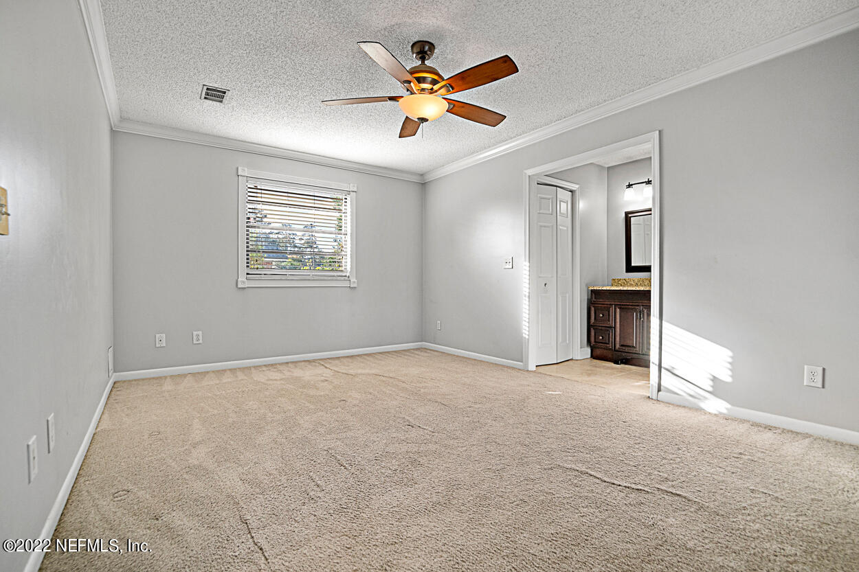 3759 Rustic Lane Jacksonville, FL 32217 - Photo 24 of 32 an empty room with ceiling fan and windows