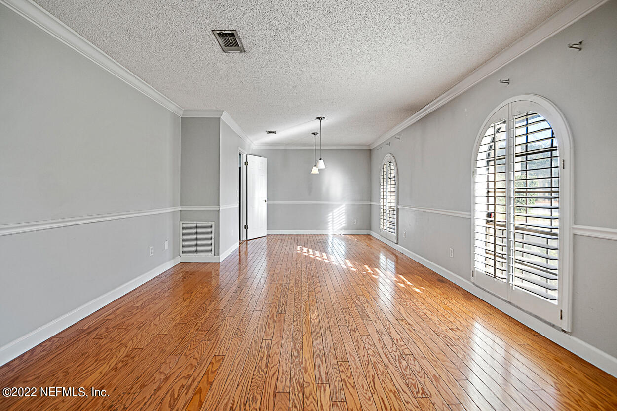 3759 Rustic Lane Jacksonville, FL 32217 - Photo 4 of 32 a view of empty room with wooden floor and fan