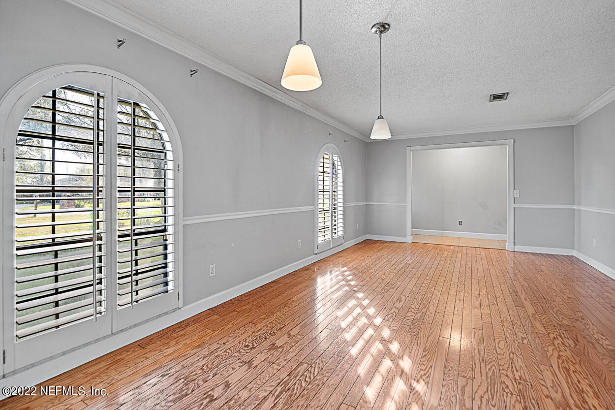 3759 Rustic Lane Jacksonville, FL 32217 - Photo 6 of 32 a view of empty room with wooden floor and fan