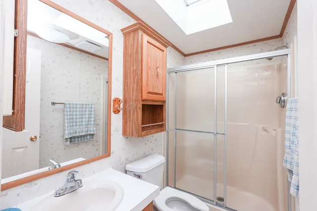 a bathroom with a sink a vanity and a shower