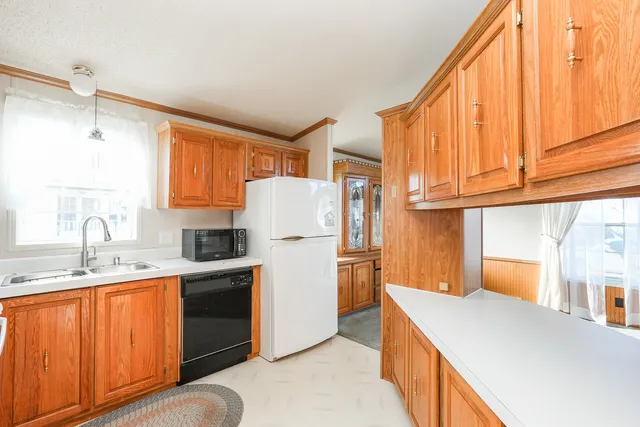 a kitchen with a refrigerator a sink and cabinets