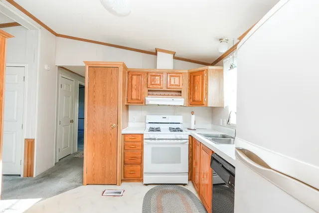 a kitchen with a stove cabinets and a refrigerator