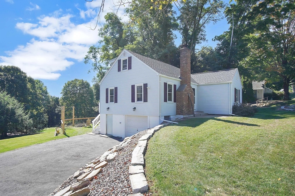 123 Stebbins Road Monson, MA 01057 - Photo 2 of 42 a front view of a house with a yard and garage