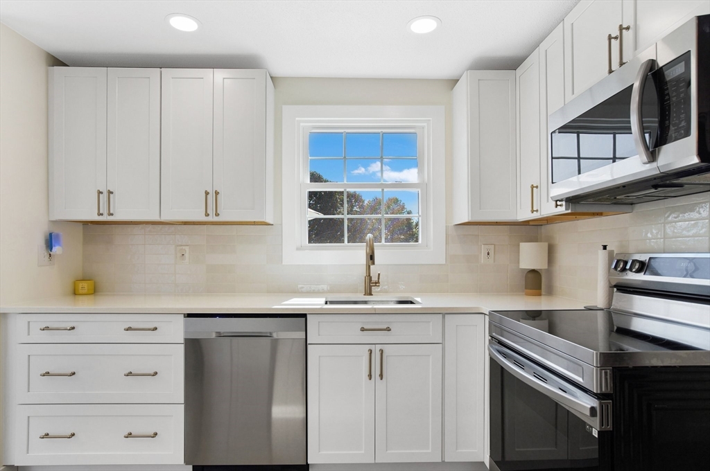 123 Stebbins Road Monson, MA 01057 - Photo 10 of 42 a kitchen with stainless steel appliances white cabinets and a sink