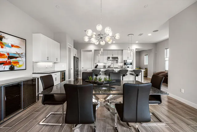 a living room with furniture a fireplace and a chandelier