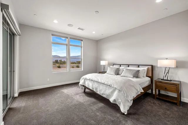 a spacious bedroom with a bed and a window