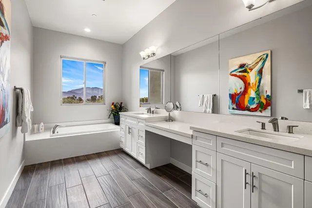a bathroom with a tub sink and mirror