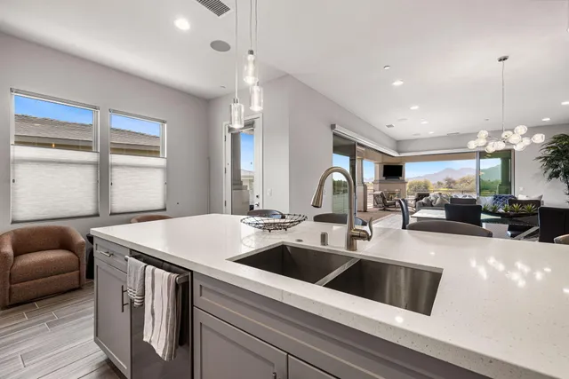 a kitchen with stainless steel appliances granite countertop a sink a stove and a refrigerator