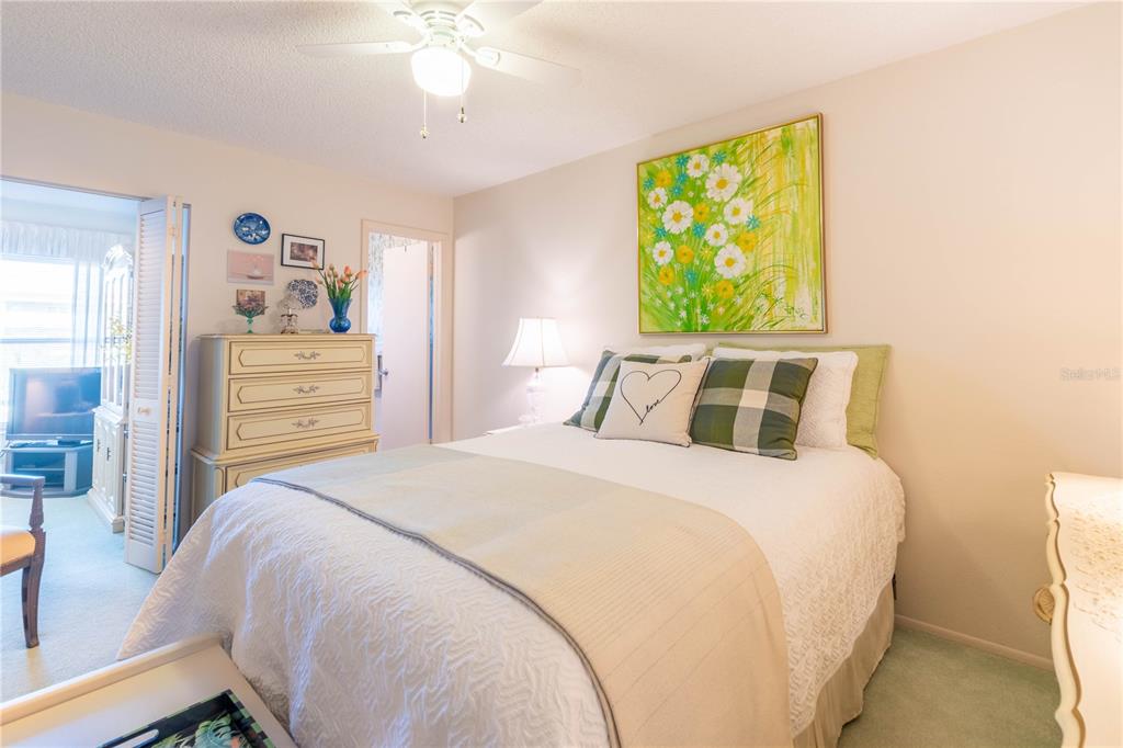 2310 Denmark Street, Unit 46 Clearwater, FL 33763 - Photo 18 of 44 a bedroom with a bed and a dresser