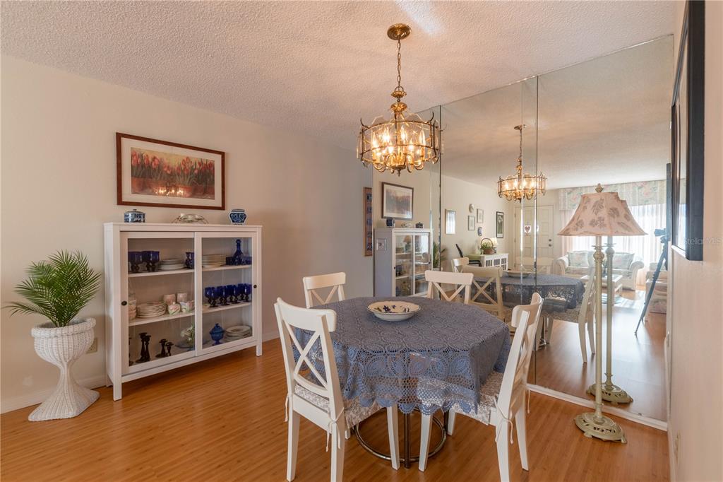 2310 Denmark Street, Unit 46 Clearwater, FL 33763 - Photo 8 of 44 a view of a dining room with furniture and wooden floor
