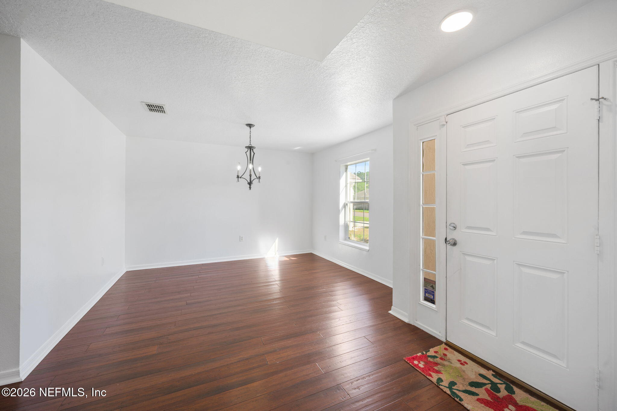 5470 Turkey Creek Road Jacksonville, FL 32244 - Photo 14 of 49 an empty room with wooden floor and windows