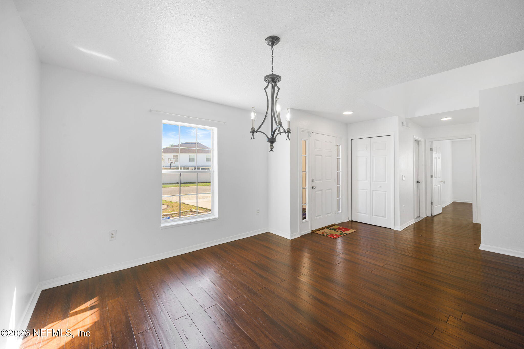 5470 Turkey Creek Road Jacksonville, FL 32244 - Photo 15 of 49 a view of an empty room with wooden floor and a window
