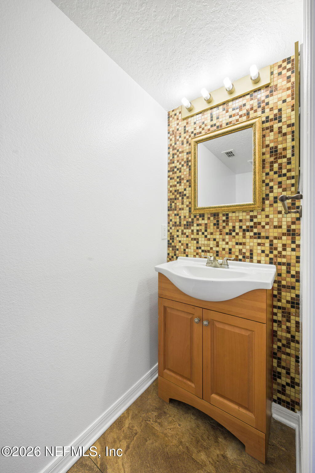 5470 Turkey Creek Road Jacksonville, FL 32244 - Photo 17 of 49 a bathroom with a sink and a mirror