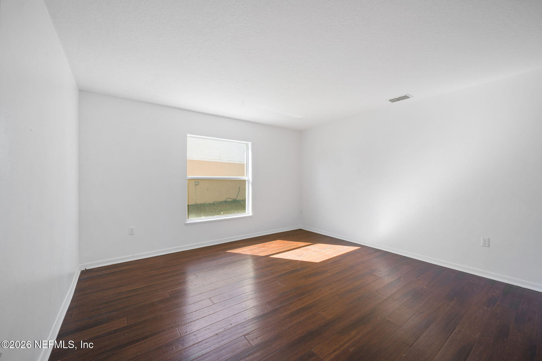 5470 Turkey Creek Road Jacksonville, FL 32244 - Photo 20 of 49 an empty room with wooden floor and windows