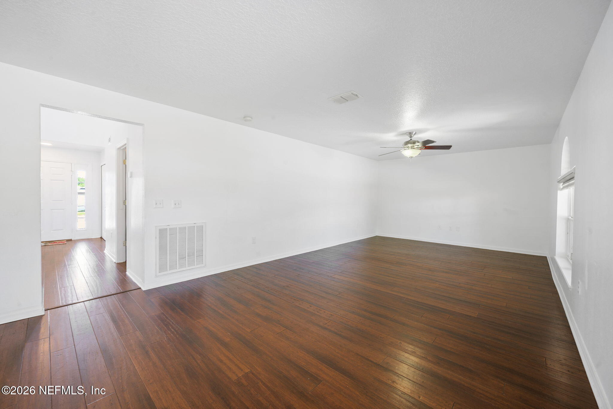 5470 Turkey Creek Road Jacksonville, FL 32244 - Photo 25 of 49 an empty room with wooden floor and windows