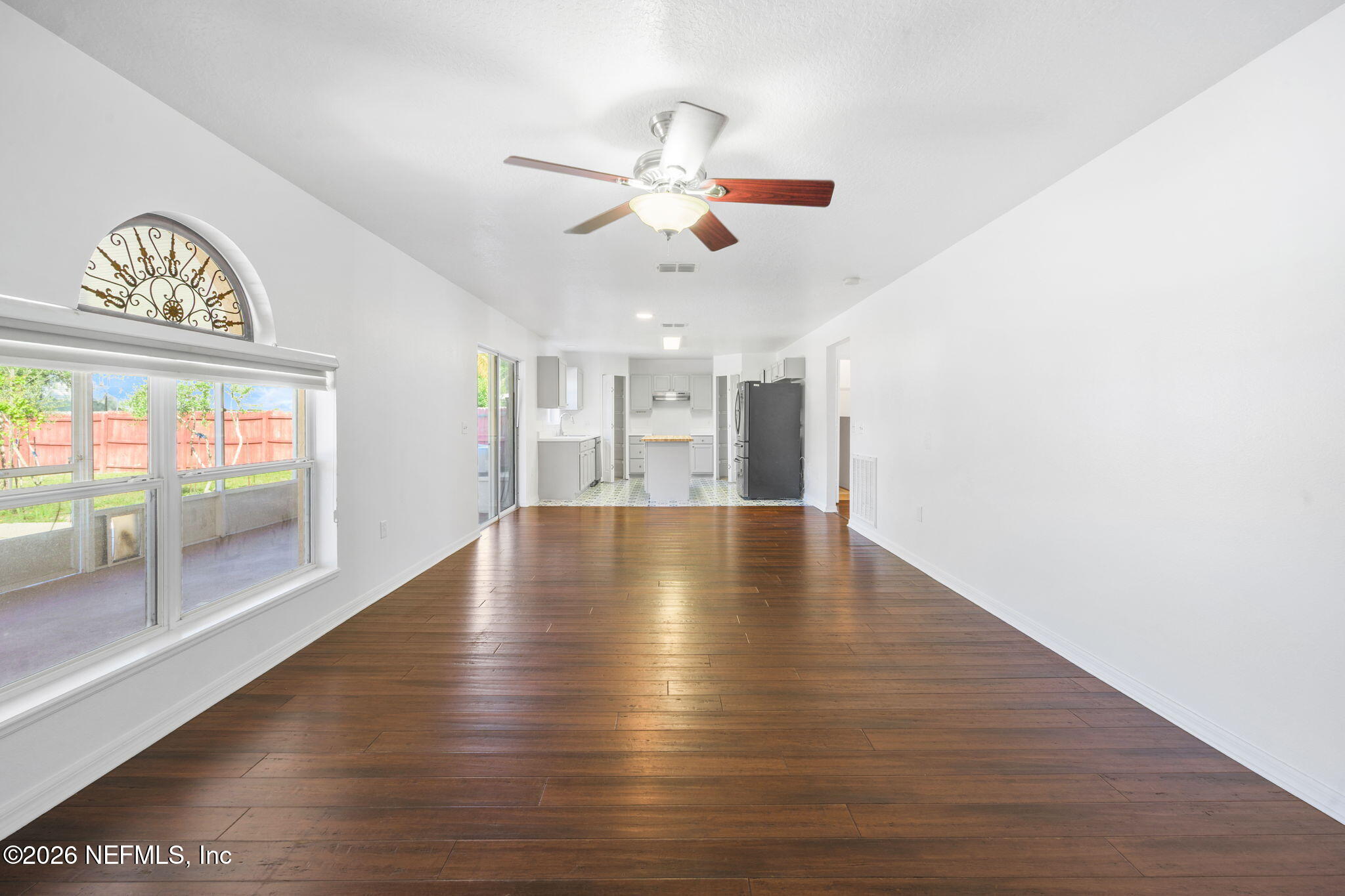 5470 Turkey Creek Road Jacksonville, FL 32244 - Photo 26 of 49 a view of empty room with wooden floor and fan