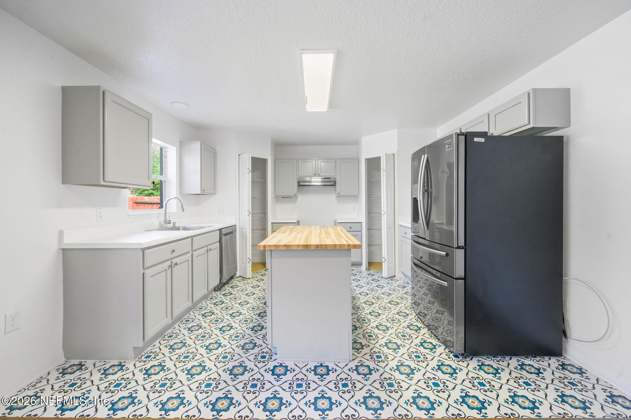 5470 Turkey Creek Road Jacksonville, FL 32244 - Photo 27 of 49 a kitchen with a refrigerator and a sink