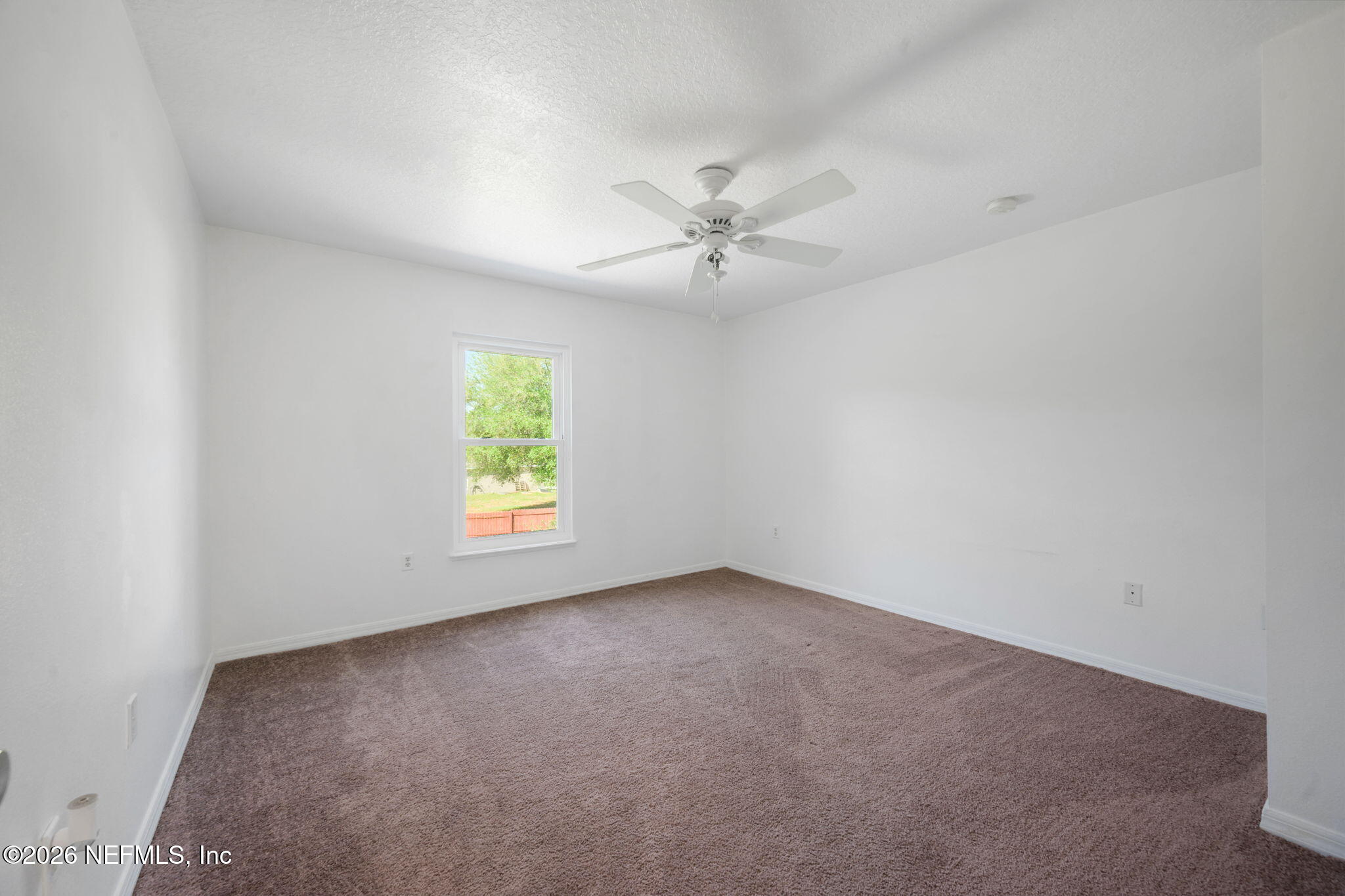 5470 Turkey Creek Road Jacksonville, FL 32244 - Photo 33 of 49 an empty room with windows and fan