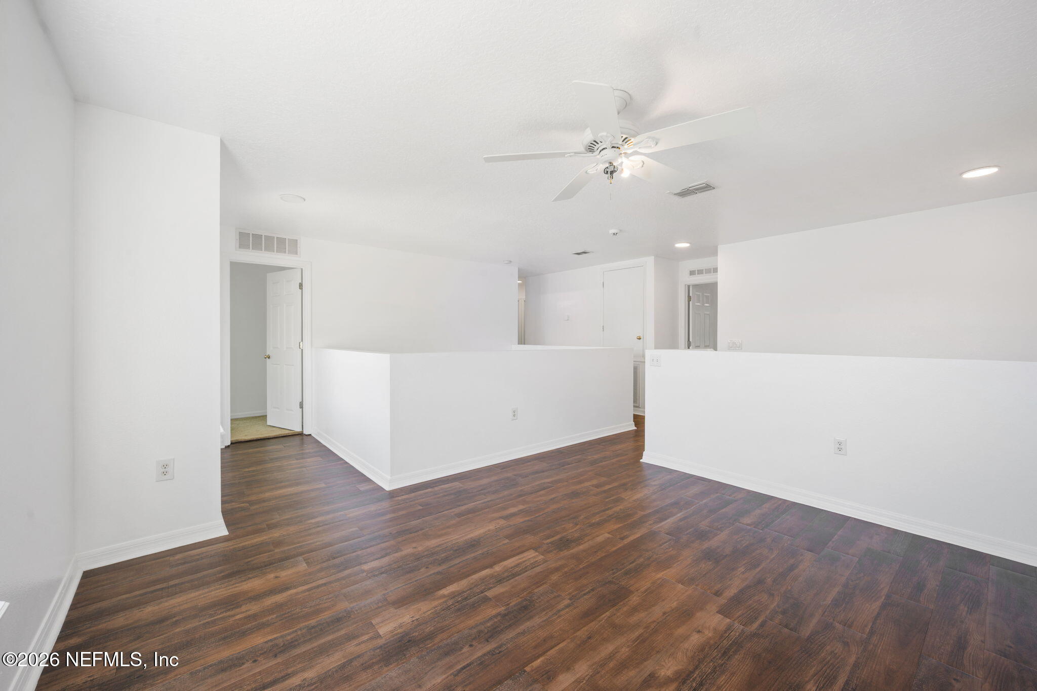 5470 Turkey Creek Road Jacksonville, FL 32244 - Photo 40 of 49 a view of an empty room with wooden floor and a ceiling fan