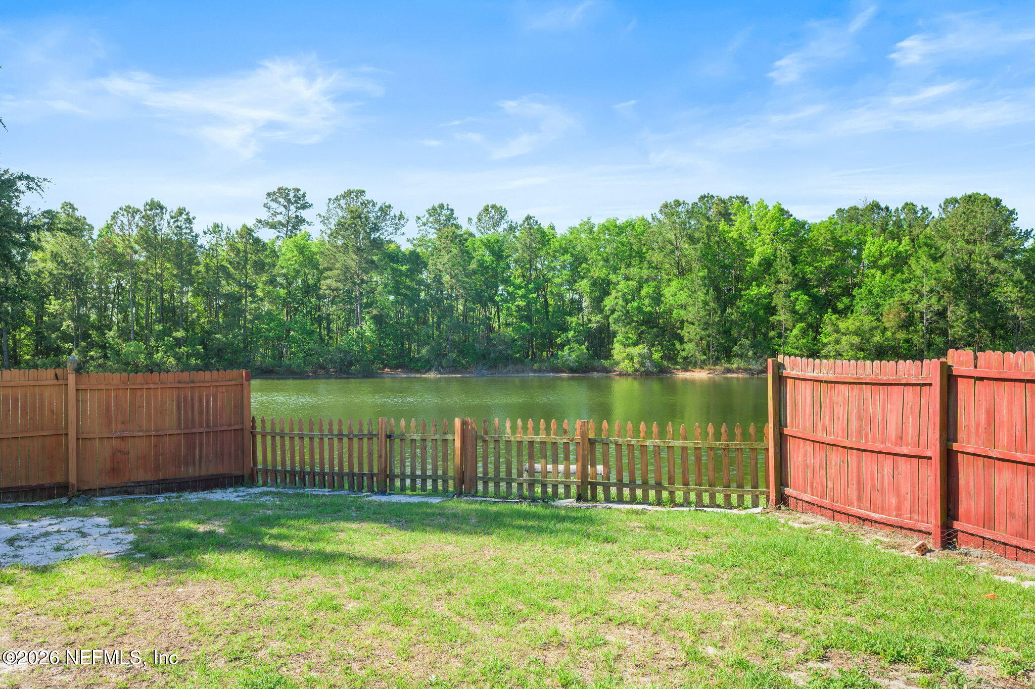 5470 Turkey Creek Road Jacksonville, FL 32244 - Photo 9 of 49 a backyard of a house with lots of green space and lake view