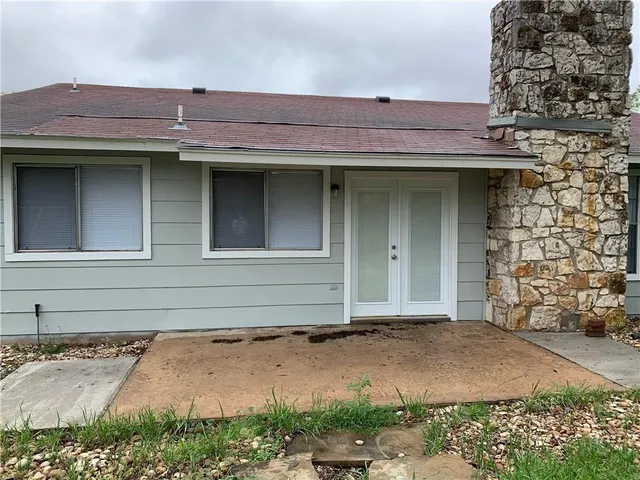 a view of a brick house with plants