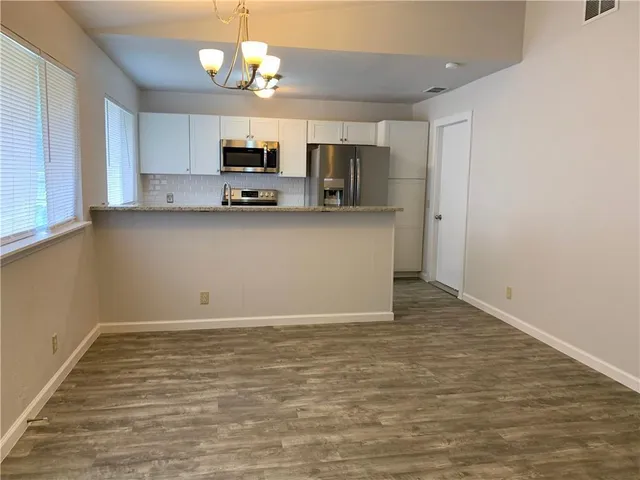 a view of kitchen with microwave and cabinets